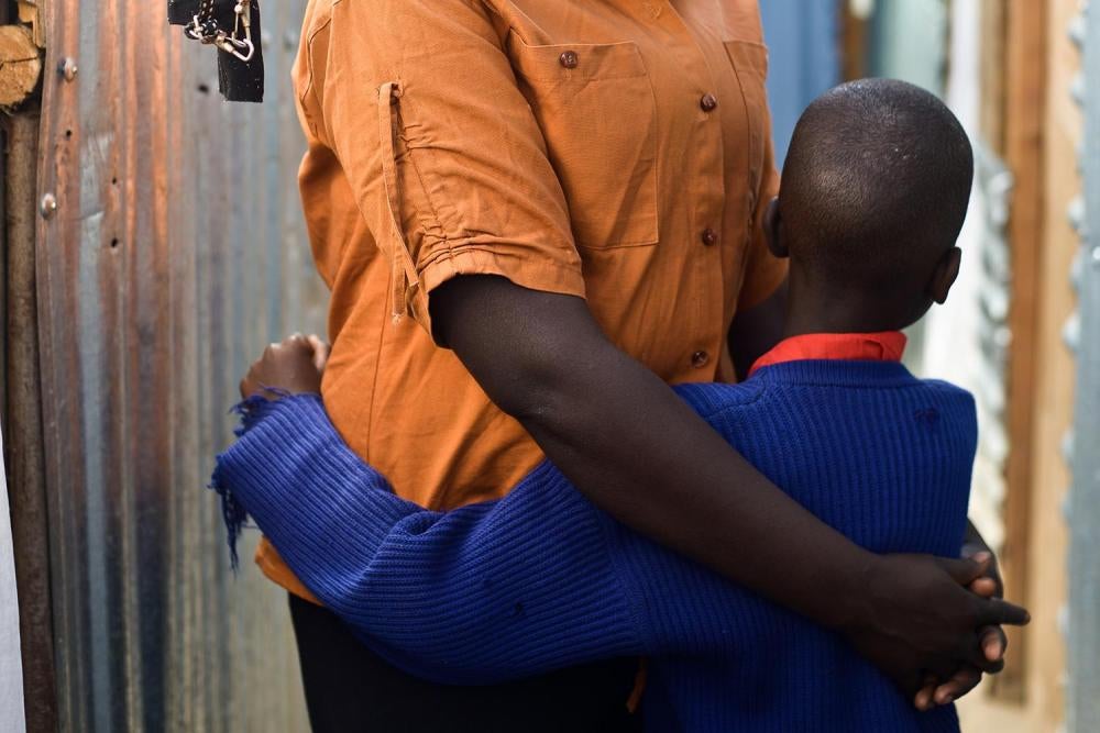 Kamene F. stands outside her house in a slum in Nairobi with her 7-year-old son born from rape.