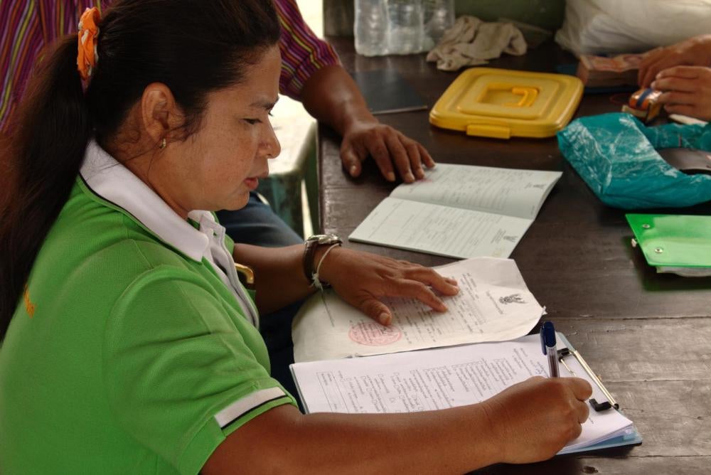 A Department of Fisheries official reviews a fishing vessel’s documents during a PIPO inspection in Surat Thani city, September 9, 2016.