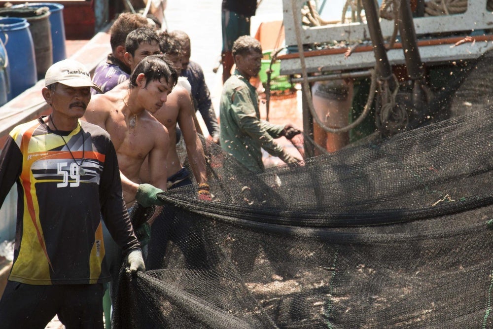 Fishers clean and prepare nets at a port in Phuket, Thailand, March 2016. 