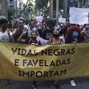 People protest against police killings in front of the Guanabara Palace, the residence of the Rio de Janeiro State Governor, on May 31, 2020. One sign reads “Black Lives Matter.”