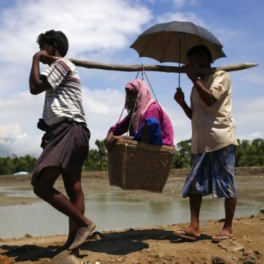 Rohingya people refugees carry an older woman on the way to camp at Shahpori Island, in Teknaf, Bangladesh on September 13, 2017. 