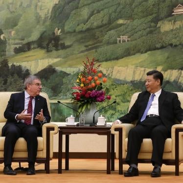 Two men speak to each other while seated