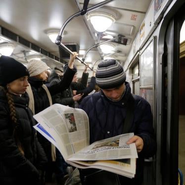 A man reads a newspaper at a metro station, in Kiev, Ukraine, February 12, 2015.