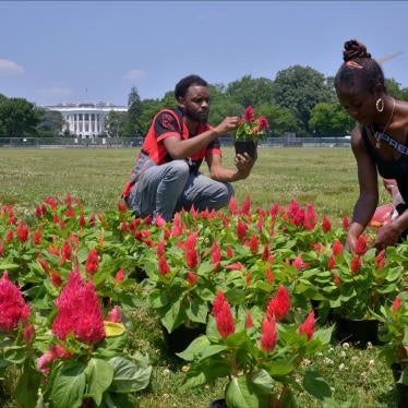 Kehmari Norman, a community garden specialist in DC and owner of Black Flower Market (BLK FLWR MRKT) and a local volunteer tend to a 150-foot garden planted outside the White House to raise awareness for reparations for the legacy of slavery, in Washington, DC. 