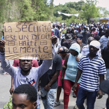 A protester holds up a sign that reads in French, "Security is a right, Haiti deserves it" during a demonstration in Port-au-Prince, Haiti, April 2, 2025.
