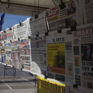 Newspapers hanging on a kiosk 