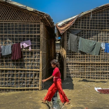 A Rohingya girl walks past shelters in a refugee camp in Cox's Bazar, Bangladesh, March 9, 2025.