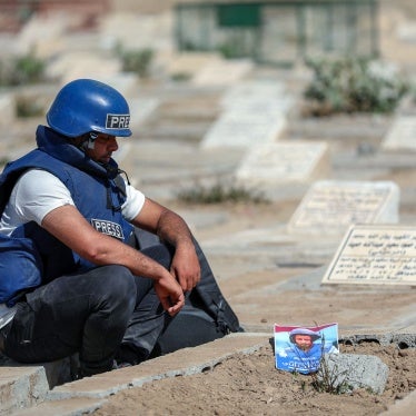 A journalist mourns the death of TV reporter Adib al-Janani at their gravesite
