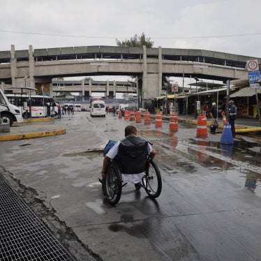 A wheelchair user searches for options to cross an under bridge while dredging work is carried out after a historic heavy rainfall in Mexico City, Mexico, on August 10, 2025.
