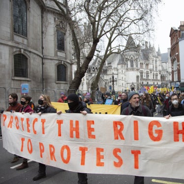 Demonstrators hold a banner that reads "Protect the right to protest"