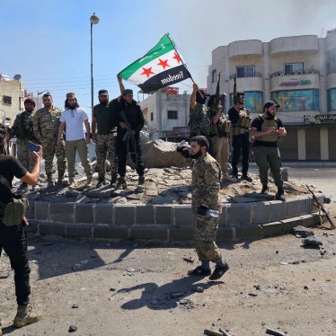 Syria's security forces pose for a picture on a roundabout in the predominantly Druze city of Sweida on July 15, 2025, following clashes between Bedouin communities and Druze fighters. Syrian government forces entered the majority Druze city of Sweida on July 15, 2025, the interior ministry said, aiming to end clashes with Bedouin communities  that have killed nearly 100 people.