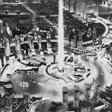 A foreign domestic worker with a child under a billboard in Dubai, the United Arab Emirates.