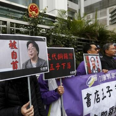 Members from the pro-democracy Civic Party carry a portrait of Gui Minhai (L) and Lee Bo during a protest outside the Chinese Liaison Office in Hong Kong, China on January 19, 2016.