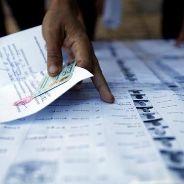 People search for their names on a voting list during commune elections in Phnom Penh, Cambodia, June 4, 2017.
