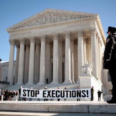 Protesters calling for an end to the death penalty unfurl a banner before police arrest them outside the U.S. Supreme Court in Washington January 17, 2007.