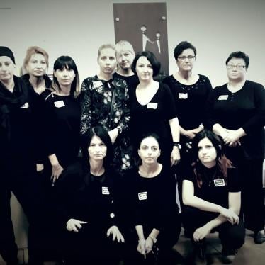 Ewa Wnorowska and her colleagues pose for a photograph in support of women's rights in Poland