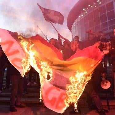 Demonstrators in Tbilisi burn an LGBT flag before the screening of the film And Then We Danced.
