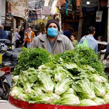A street vendor pushes his cart in Shatila Palestinian refugee camp, wearing a face mask to try to protect against the spread of COVID-19, in Beirut suburbs, Lebanon, March 30, 2020.